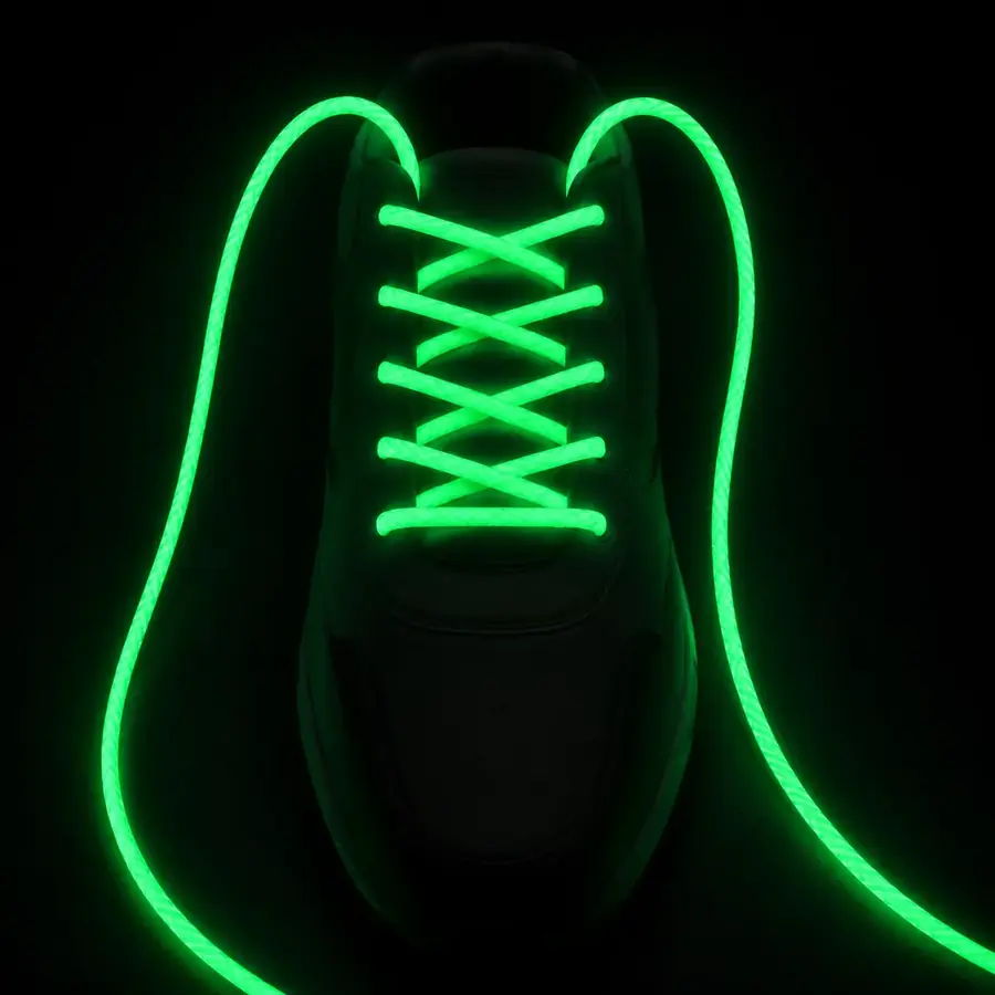 Round shoelace glowing bright green in darkness